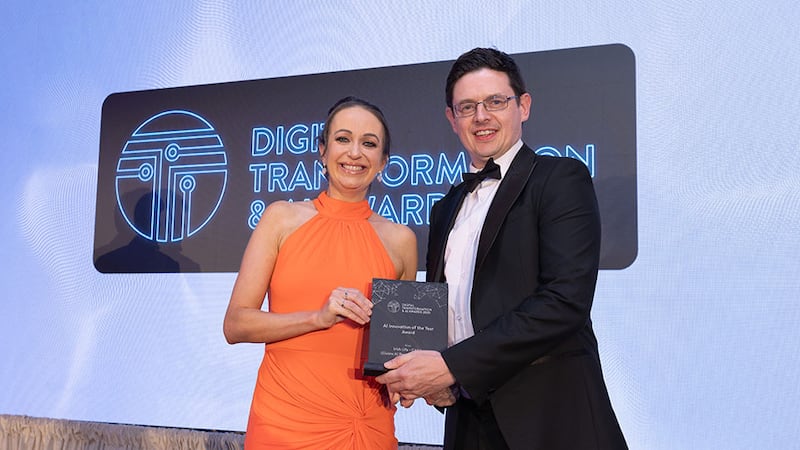 Cliona McParland, awards judge, presents the AI innovation of the year award to Martin Donovan, Irish Life