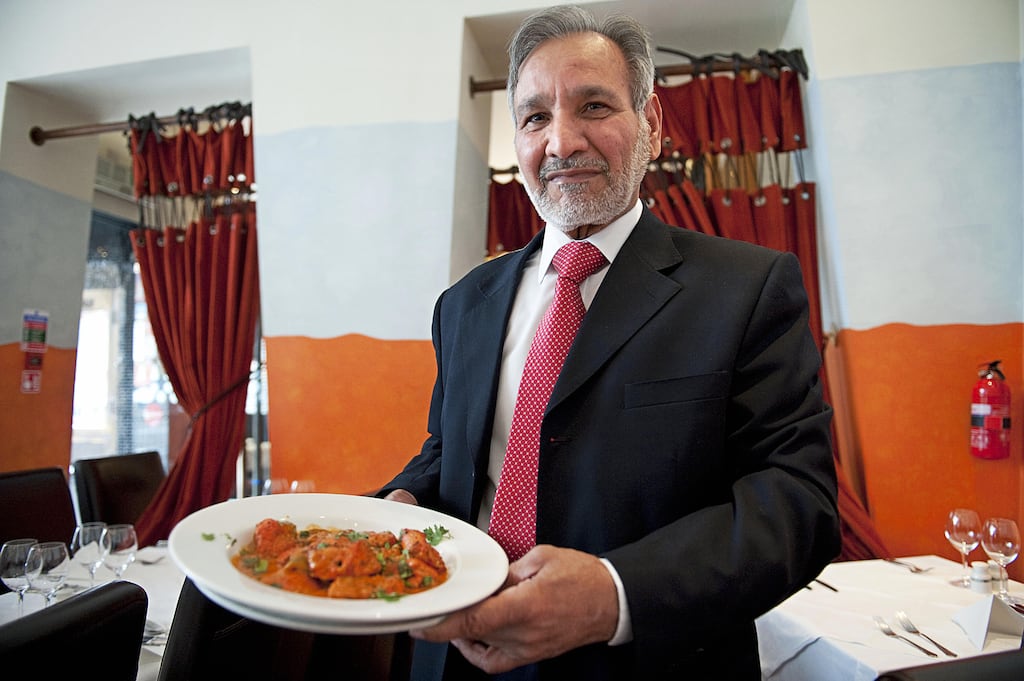 Ahmed Aslam Ali, owner of the Shish Mahal restaurant in Glasgow, Scotland, with a plate of chicken tikka masala in his restaurant in 2009. Photograph: Andy Buchanan/AFP/Getty