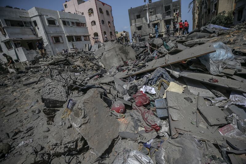 Palestinians inspect a destroyed house that belongs to Shamlakh family after Israeli air strikes in the south of Gaza City. Photograph: Mohammed Saber/EPA