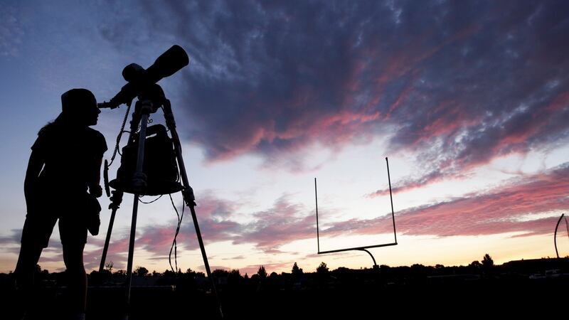A woman watches through a telescope  at Madras High School ahead of  a solar eclipse in Madras, Oregon, US.  Photograph: Jason Redmond/Reuters