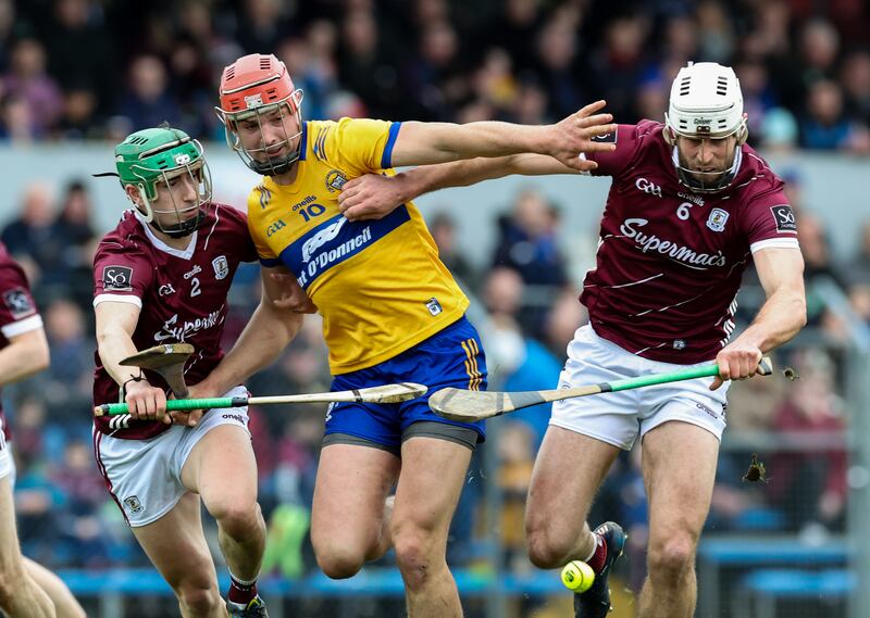 Clare's Peter Duggan tackled by Jack Grealish and Gearoid McInerney of Galway. Photograph: Lorraine O’Sullivan/Inpho