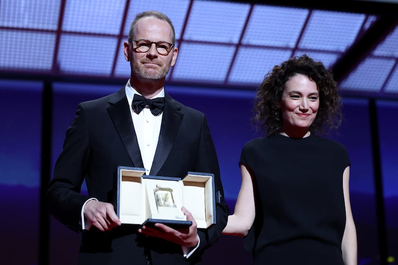 Joachim Trier accepts the Grand Prix Award for Sentimental Value from Coralie Fargeat at the Cannes film festival on Saturday. Photograph: Pascal Le Segretain/Getty Images