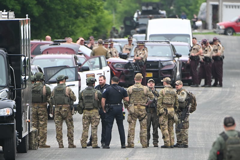 Authorities gather at a baseball park in Green Isle, Minnesota, as they search for a suspect in the shootings of politicians. Photograph: Craig Lassig/EPA