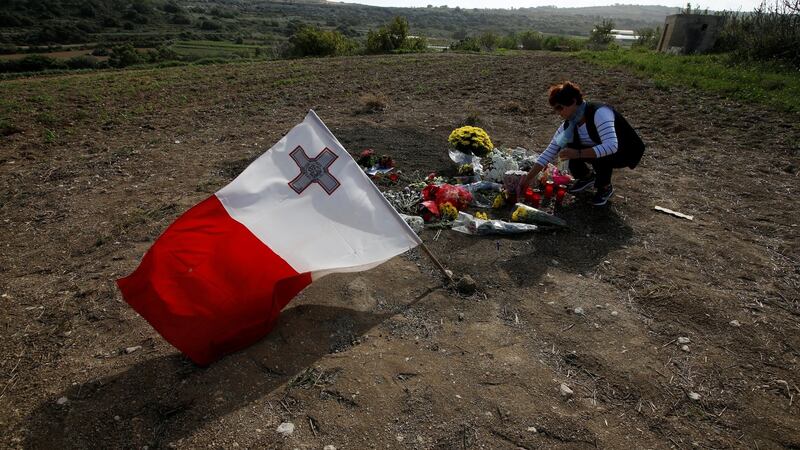 A woman places flowers at the scene of the assassination of investigative journalist Daphne Caruana Galizia, killed in a car bomb attack  in Malta on October 16th, 2017. Photograph: Darrin Zammit Lupi / Reuters