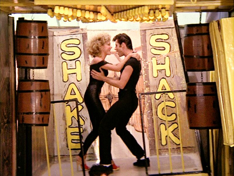 Newton-John with John Travolta in 1978’s Grease. Photograph:   Paramount Pictures/CBS/Getty Images