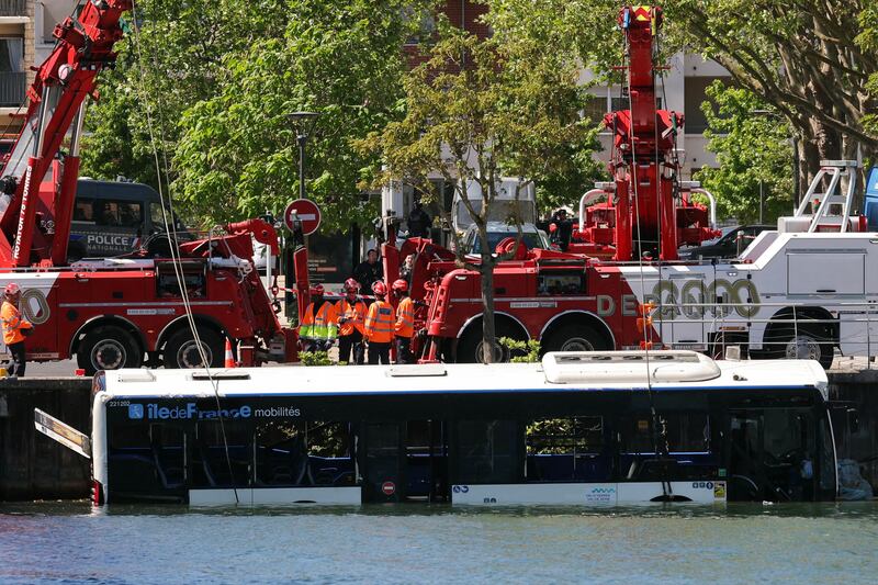The driver and three other people who were on the bus were rescued. Photograph: Thomas Samson/AFP/Getty