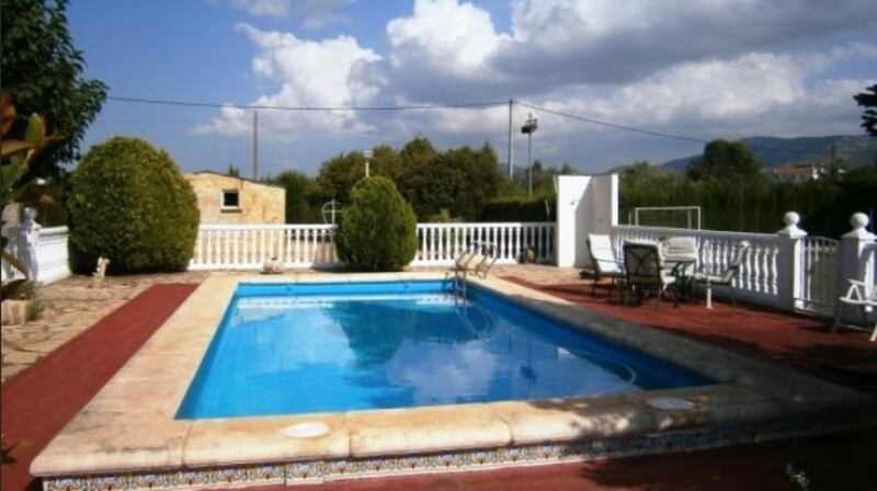 This  finca sits in fenced land with a swimming pool and a football pitch.