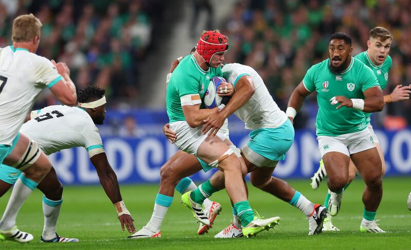 Josh van der Flier is hit hard in a tackle by South African defenders. Photograph: James Crombie/Inpho
