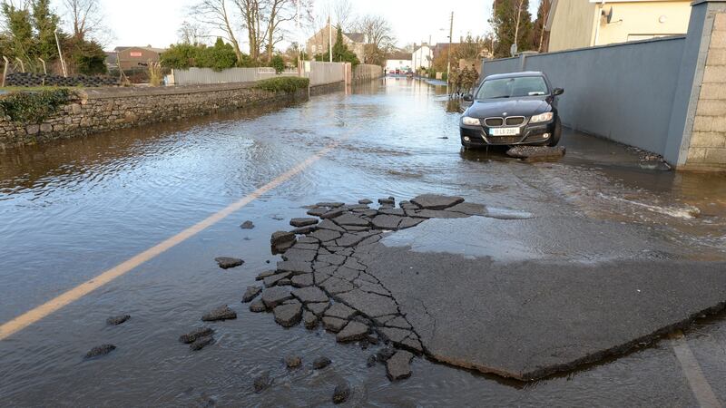 The damaged surface of  Manor Road in Mountmellick after local rivers burst their banks on Wednesday. Photograph: Alan Betson/The Irish Times