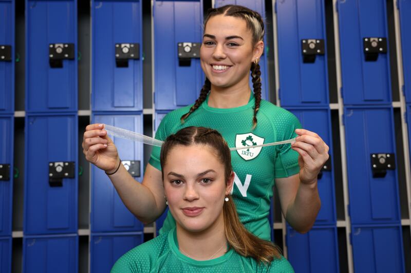Kayla Waldron ties a bow in Leah Tarpey's hair. Photograph: Laura Hutton