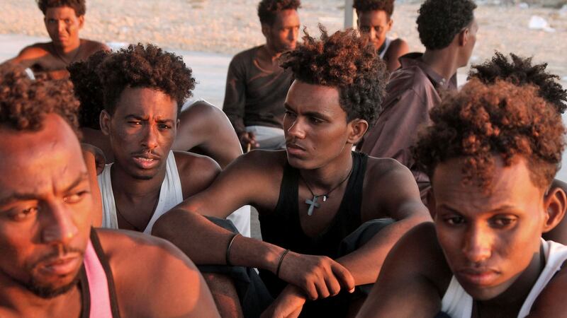Rescued migrants sit on the coast of Khoms, Libya. Photograph: AFP/Getty Images