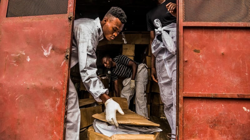 Workers from the St Luke Foundation collect abandoned bodies from the Zenith Funeral home in Port-au-Prince, Haiti. Photograph: Daniel Berehulak/The New York Times