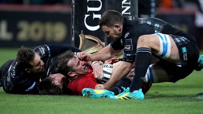 Munster’s JJ Hanrahan is tackled by George Horne, Ruaridh Jackson and Adam Ashe of Glasgow Warriors on the try line during their Pro14 encounter at Thomond Park. Photo: Dan Sheridan/Inpho