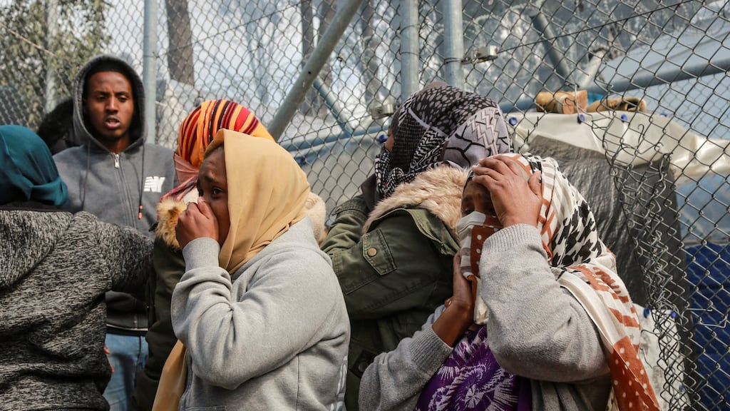 Refugees and migrants move away from the camp of Moria in the island of Lesbos on Monday after a fire broke out. Photograph: Manolis Lagoutaris/AFP via Getty Images
