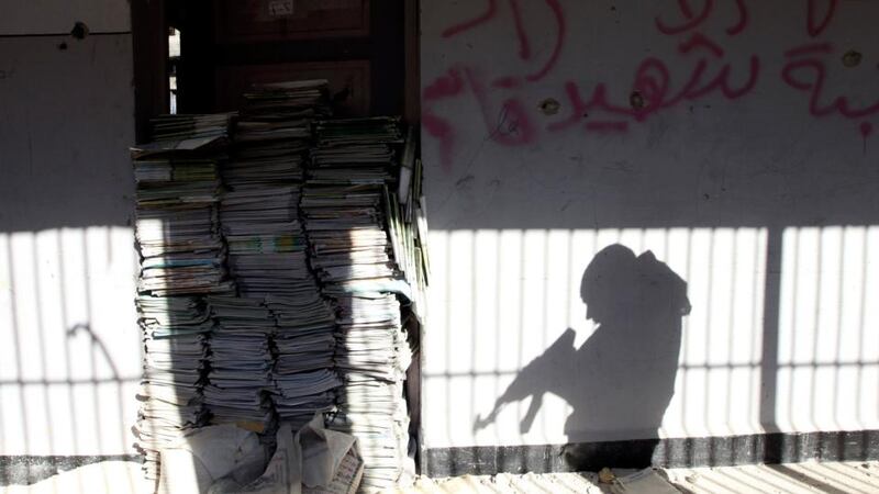 The shadow of a soldier is cast on a wall of a school in Sheikh Maksoud area in Aleppo. Photograph: Muzaffar Salman/Reuters
