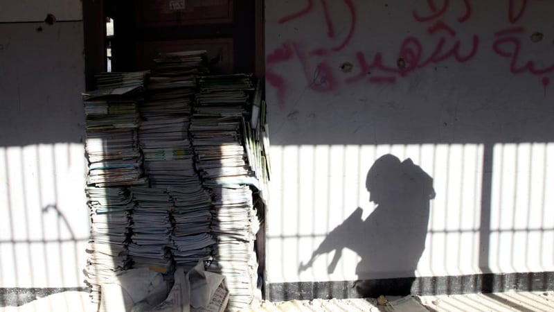 The shadow of a soldier is cast on a wall of a school in Sheikh Maksoud area in Aleppo. Photograph: Muzaffar Salman/Reuters