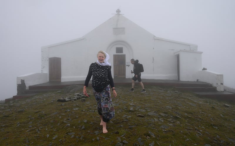 The tiny church on Croagh Patrick – scene of hourly masses since 6am – was flying the green and red Mayo flag, with its slogan 'Criost Linn'. Photograph: Michael McLaughlin