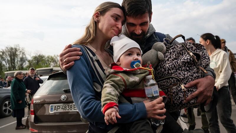 A woman and child who evacuated from Mariupol are comforted by a friend after arriving in Zaporizhzhia, Ukraine. Photograph: Lynsey Addario/The New York Times