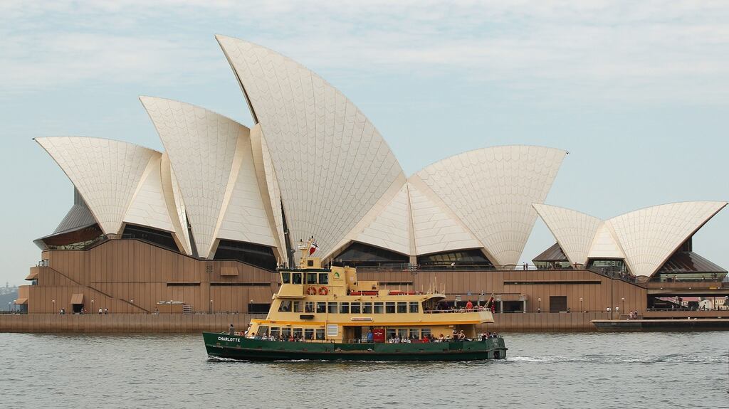 A ferry sails past the Sydney Opera House in Sydney, Australia, on Friday, April 29, 2016. Australia’s central bank on Tuesday joined a growing line of central banks in adding more stimulus, cutting its cash rate to a record low of 1.75 per cent to head off deflationary risks. (Photograph: Brendon Thorne/Bloomberg)