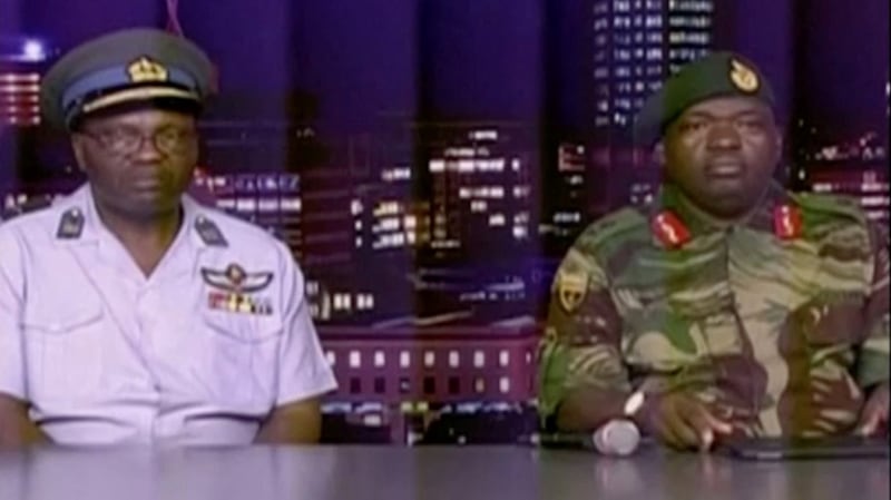 Zimbabwe defence forces major-general SB Moyo (right) makes an announcement on state broadcaster ZBC. Photograph: Reuters