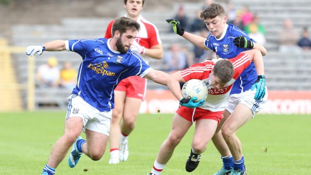 Derry’s Barry Grant in action against Cavan’s Thomas Edward Donohoe and Luke Fortune during the Ulster minor football final. Photograph: Andrew Paton/Inpho/Presseye