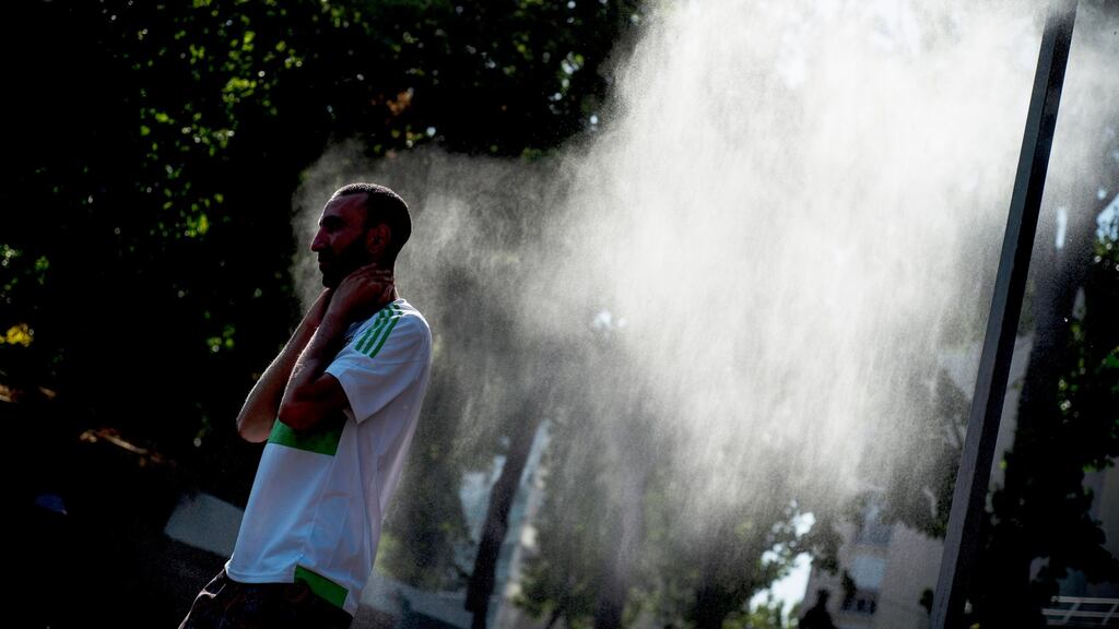 People cool down along the canal de l’Ourcq in Paris on Wednesday. Photograph: Julien de Rosa/EPA