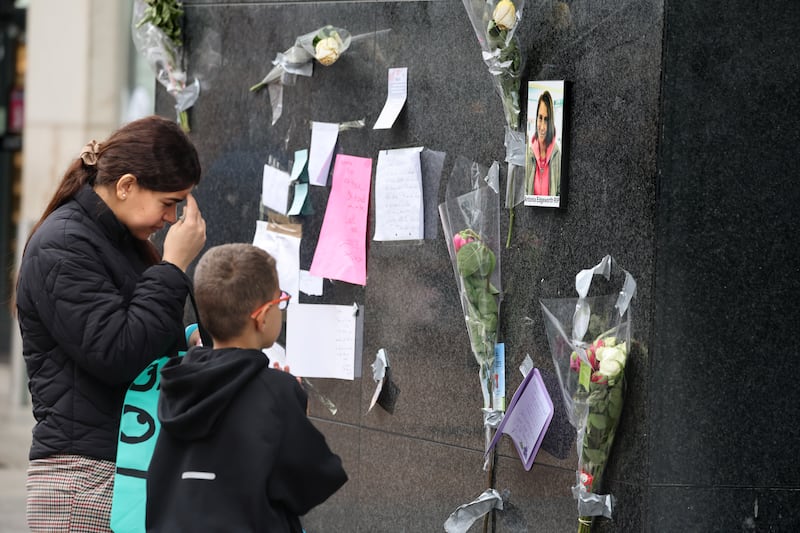People pay their respects at the Henry Street memorial. Photograph: Dara Mac Dónaill/The Irish Times