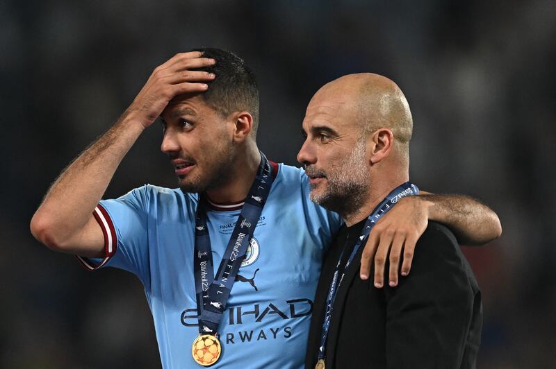 Rodri and Pep Guardiola take in the significance of Manchester City's win over Inter Milan in the 2023 Champions League final. Photograph: Paul Ellis/AFP via Getty Images