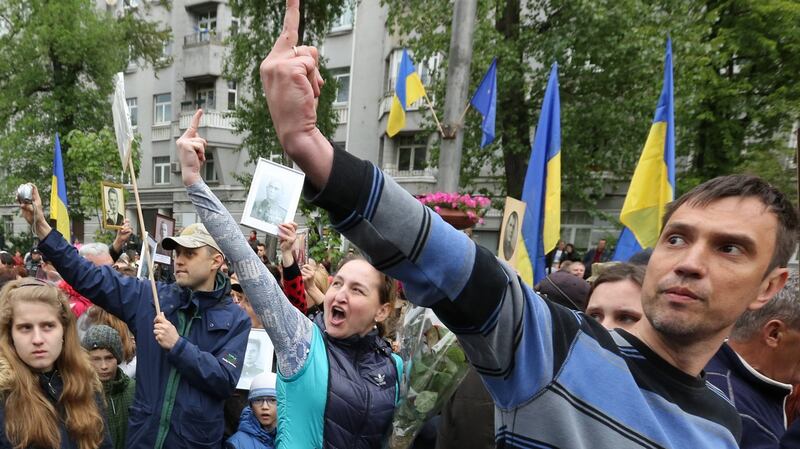 Protesters show their disrespect to OUN (Organisation of Ukrainian Nationalists) supporters during a march for Victory Day celebrations in Kiev, Ukraine. Photograph: Tatyana Zenkovich/EPA