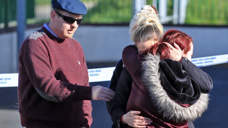 Mourners grieve at the scene of an apartment fire in Cluainin Cronan on Kilcronan Avenue, Clondalkin, where a woman and three children died in a fire. Photograph: Colin Keegan/Collins Dublin