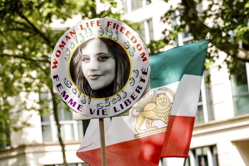 A demonstrator near the Iranian embassy in Paris carries the portrait of Mahsa Amini, who died in detention following her arrest by the Iranian morality police in September 2022, sparking months of protests and unrest. Photograph: Teresa Suarez/Shutterstock/EPA-EFE