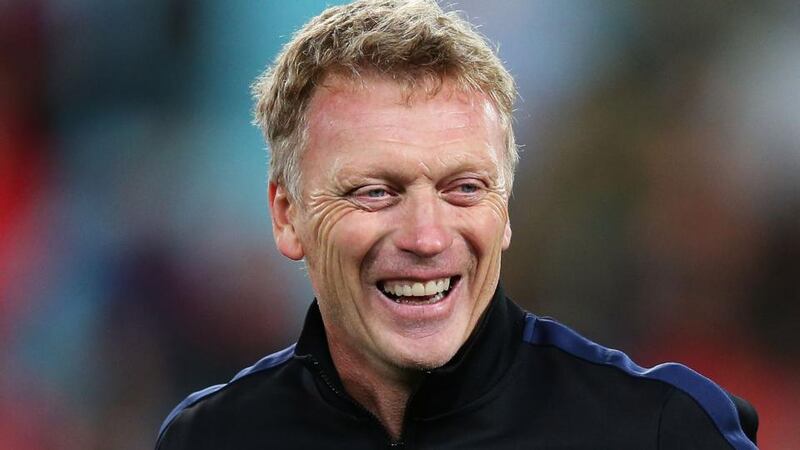 Manchester United manager David Moyes shares a joke with a coaching staff at full time. Photograph:   Brendon Thorne/Getty Images