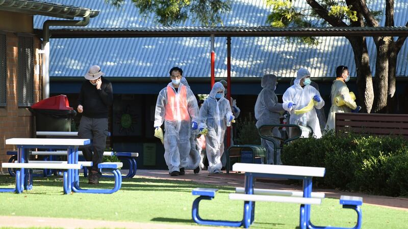 Cleaners in personal protective equipment work at Strathfield South Public School in Sydney. The school was closed by authorities after an unidentified person tested positive for Covid-19. Photograph: Joel Carrett/EPA
