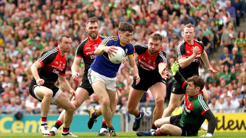 Kerry’s Paul Geaney eludes Mayo’s Keith Higgins, Séamus O’Shea, Aidan O’Shea, David Clarke and Colm Boyle.  Photograph: James Crombie/Inpho