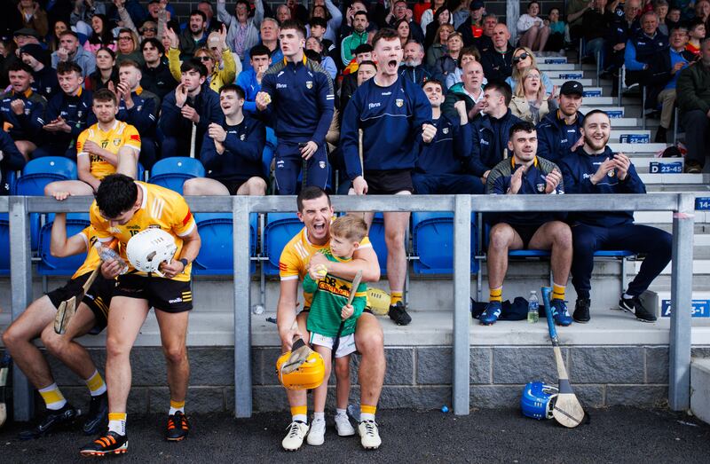 Antrim's Michael Bradley celebrates the final whistle with his son Iarlaith after the game. Photograph: Tom Maher/Inpho