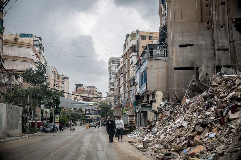 People walk past rubble in Dahiyeh. Photograph: Sally Hayden