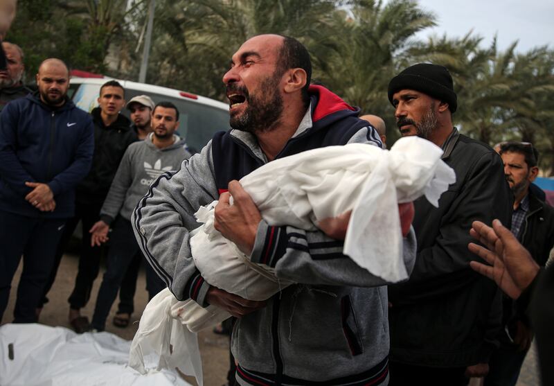 A man cradles  the body of a child killed in an Israeli air strike during a funeral in Khan Younis, in southern Gaza, on November 22nd. Photograph: Yousef Masoud/New York Times
                      