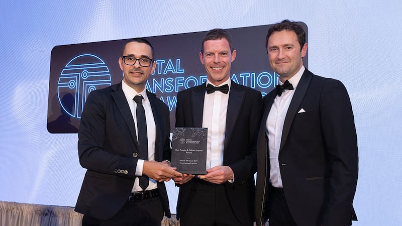 Pierangelo Rosati, awards judge, presents the best people & culture impact award to Paul Fox and Colin Reilly, Sandvik AB Group and EY
