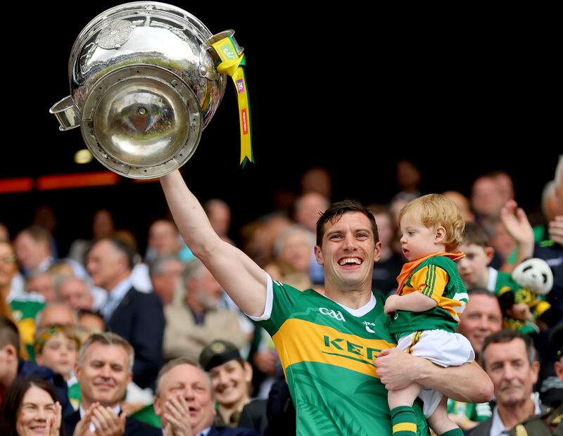 Kerry’s David Moran, with his son Eli, lifts the Sam Maguire after the All-Ireland final victory over Galway last summer. The Kingdom veteran has since announced his retirement. Photograph: James Crombie/Inpho 