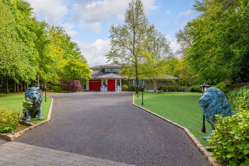 House exterior with pair of bronze lions guarding the entrance