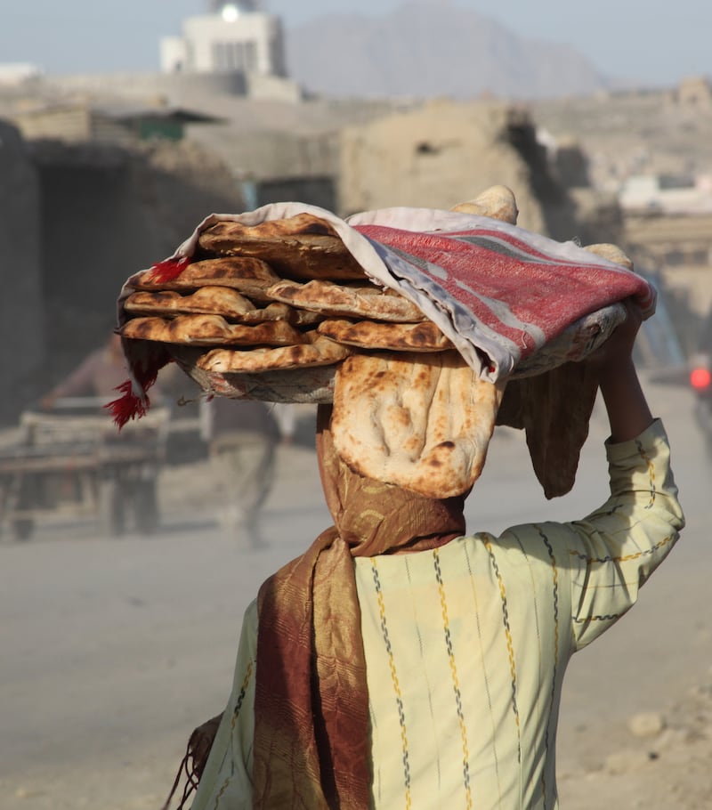 An Afghan women sells fresh bread at  the market in Kabul, Afghanistan. Photograph: Brenda Fitzsimons