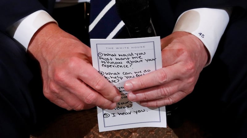 US president Donald Trump holds  a list of  prepared questions as he hosts a listening session with high school students and teachers to discuss school safety at the White House in Washington. Photograph: Jonathan Ernst/Reuters