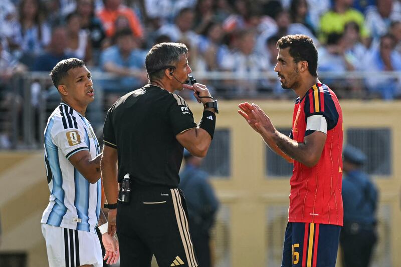 Slovenian referee Slavko Vincic speaks with Spain's Rodri. Photograph: Paul Ellis/AFP via Getty Images