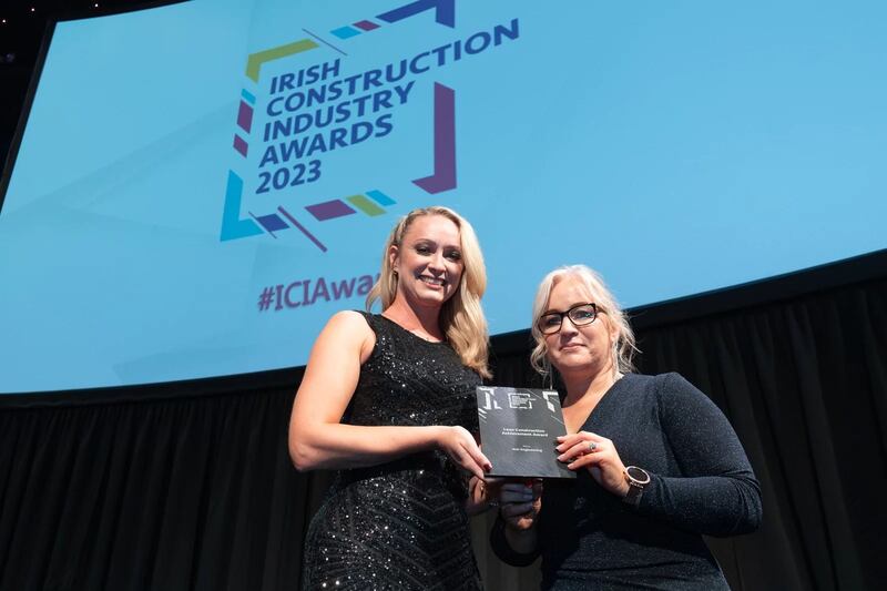 Amy Kruse, awards judge, presents the lean construction achievement award to Elaine Harrington, Suir Engineering