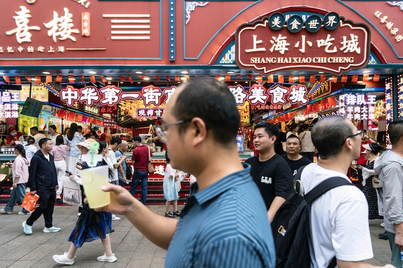 Pedestrians pass a food court in the Nanjing Road shopping area in Shanghai, China. Photograph: Qilai Shen/Bloomberg via Getty Images