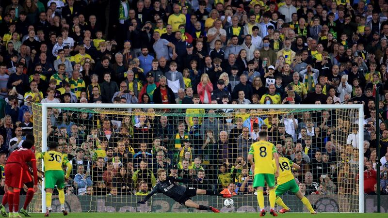 Liverpool goalkeeper Caoimhín Kelleher saves a penalty from Christos Tzolis at Carrow Road. Photograph: Stephen Pond/Getty Images