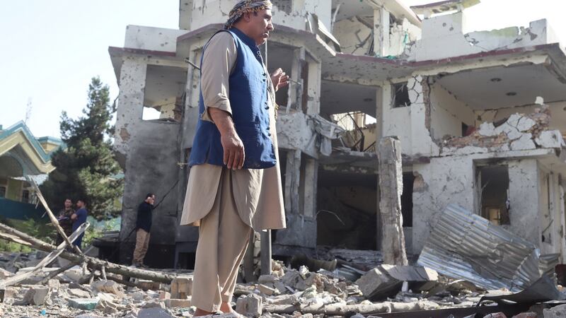 Afghan security officials stand guard on Wednesday outside the house of acting defence minister Gen  Bismillah Mohammadi, after an overnight explosion and attack, in Kabul. The attack comes at a time of marked instability in Afghanistan. Photograph: Jawed Kargar/EPA