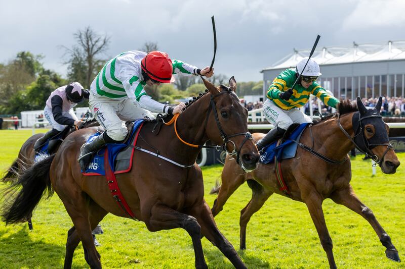 Mark Walsh onboard Mystical Power (green and gold silks) beats Jack Kennedy onboard Firefox to win the KPMG Champion Novice Hurdle at Punchestown. Photograph: Morgan Treacy/Inpho
