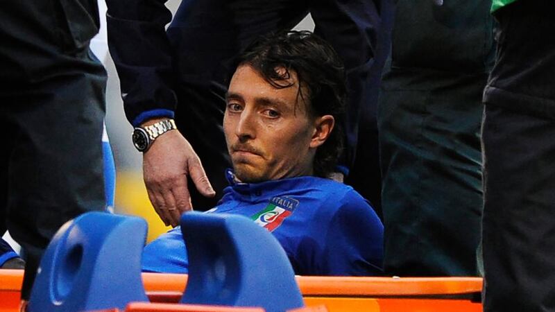 Italy’s Riccardo Montolivo before being stretchered off with a suspected broken ankle at Craven Cottage.  Photograph: Facundo Arrizabalaga /  EPA