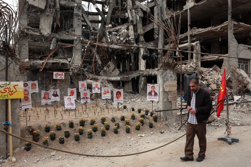 An Iranian man walks past portraits of victims reportedly killed in a US-Israeli air strike on the residential building near which they are displayed, in Tehran on Monday. Photograph: AFP via Getty
